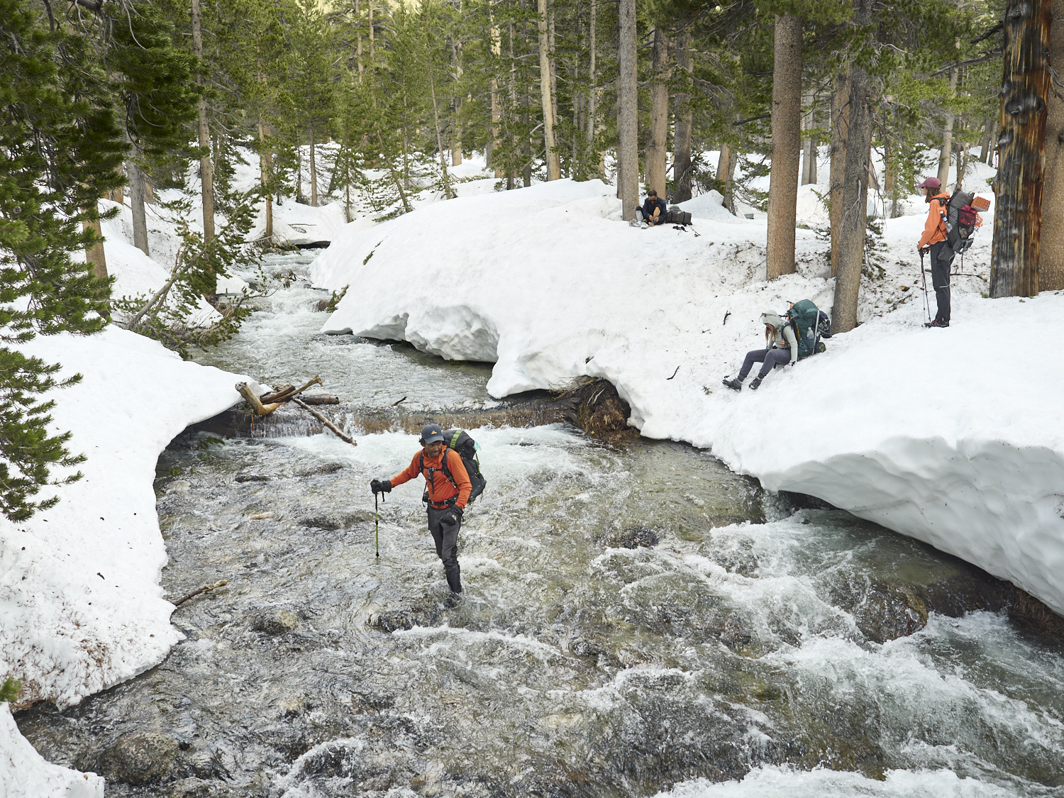 A hiker crosses the South Fork Kings River.