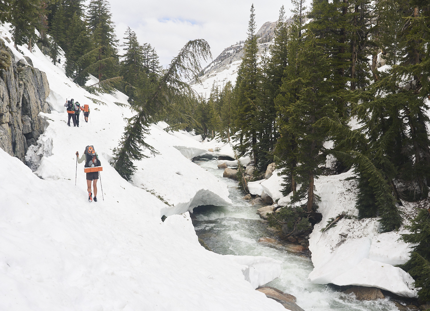 Hikers cross a steep snowfield in Kerrick Canyon above Rancheria Creek.