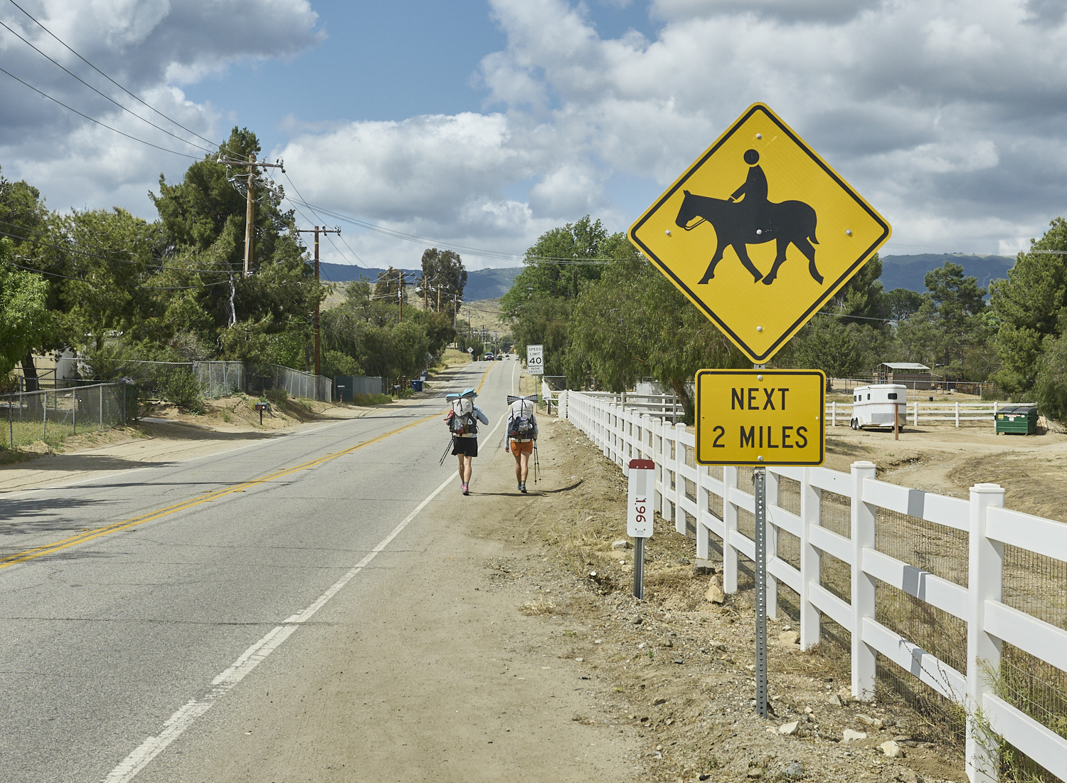 two hikers are hiking in Agua Dulce on an Highway