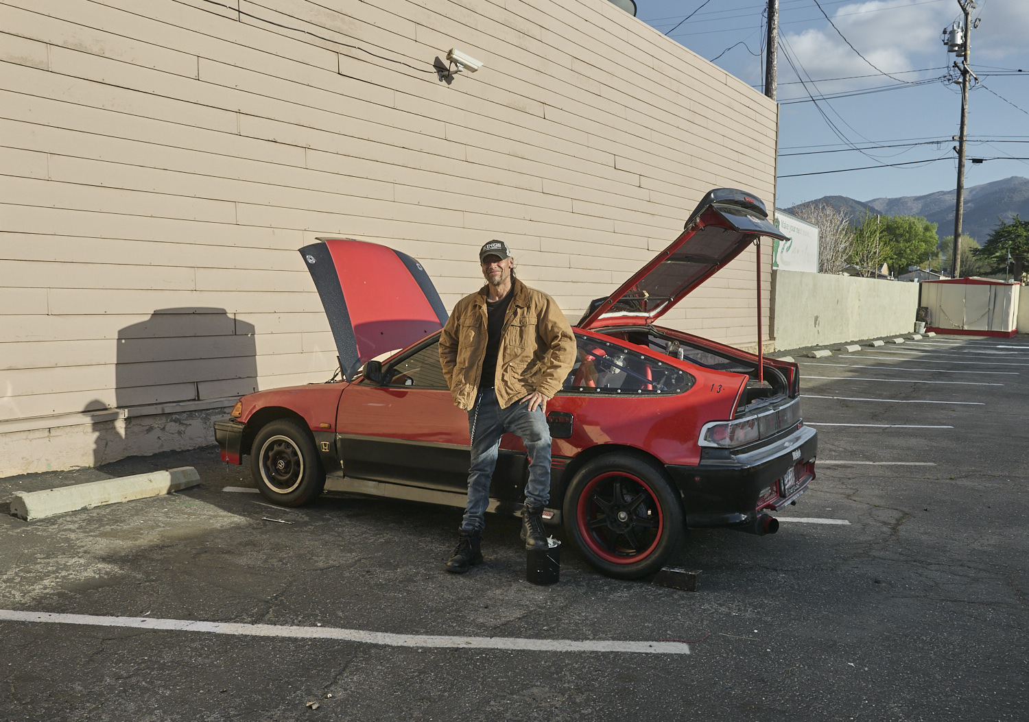 A man is servicing his Honda CRX in Tehachapi.