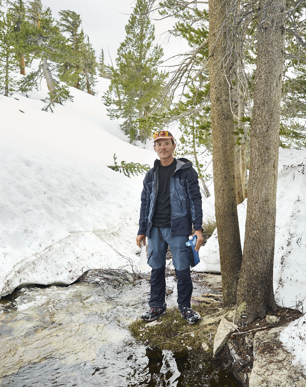 Arnaud from France fills his bottles at an open water source in the Sierra Nevada.