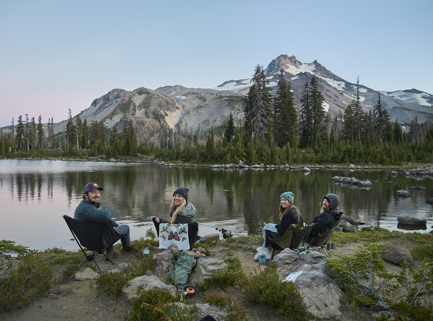 Weekend hikers are enjoying an evening in Oregon at Russell Lake with mount Jefferson in the background.