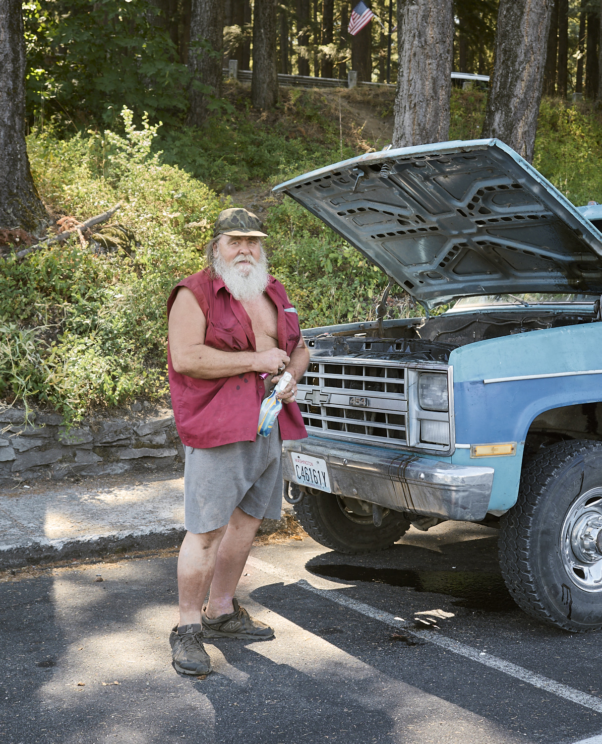 A man is servicing his old pickup truck in Cascade Locks.