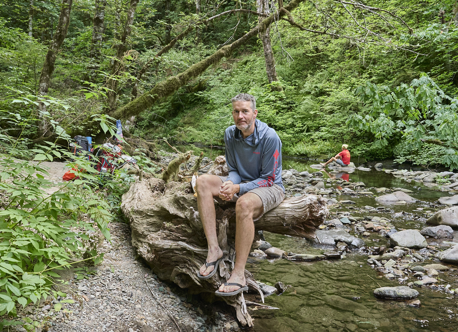 A hiker is relaxing at Snag creek in Southern Washington.