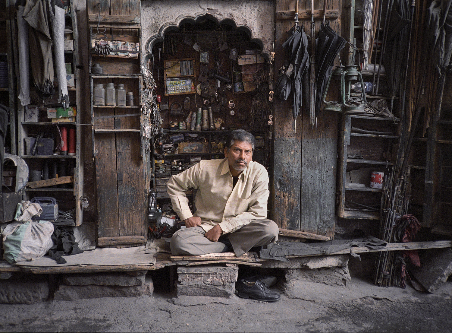 Ein Mann in seinem Reparaturladen für Regenschirme in Jodhpur (Rajasthan). 